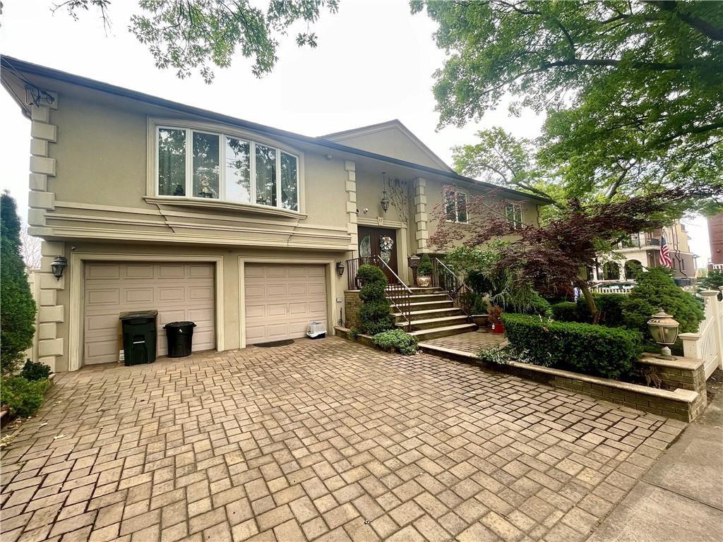 a view of a house with a yard and potted plants