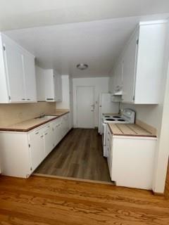 a kitchen with a cabinets and wooden floor