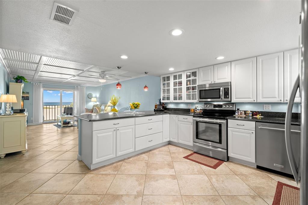 a kitchen with a sink and white cabinets