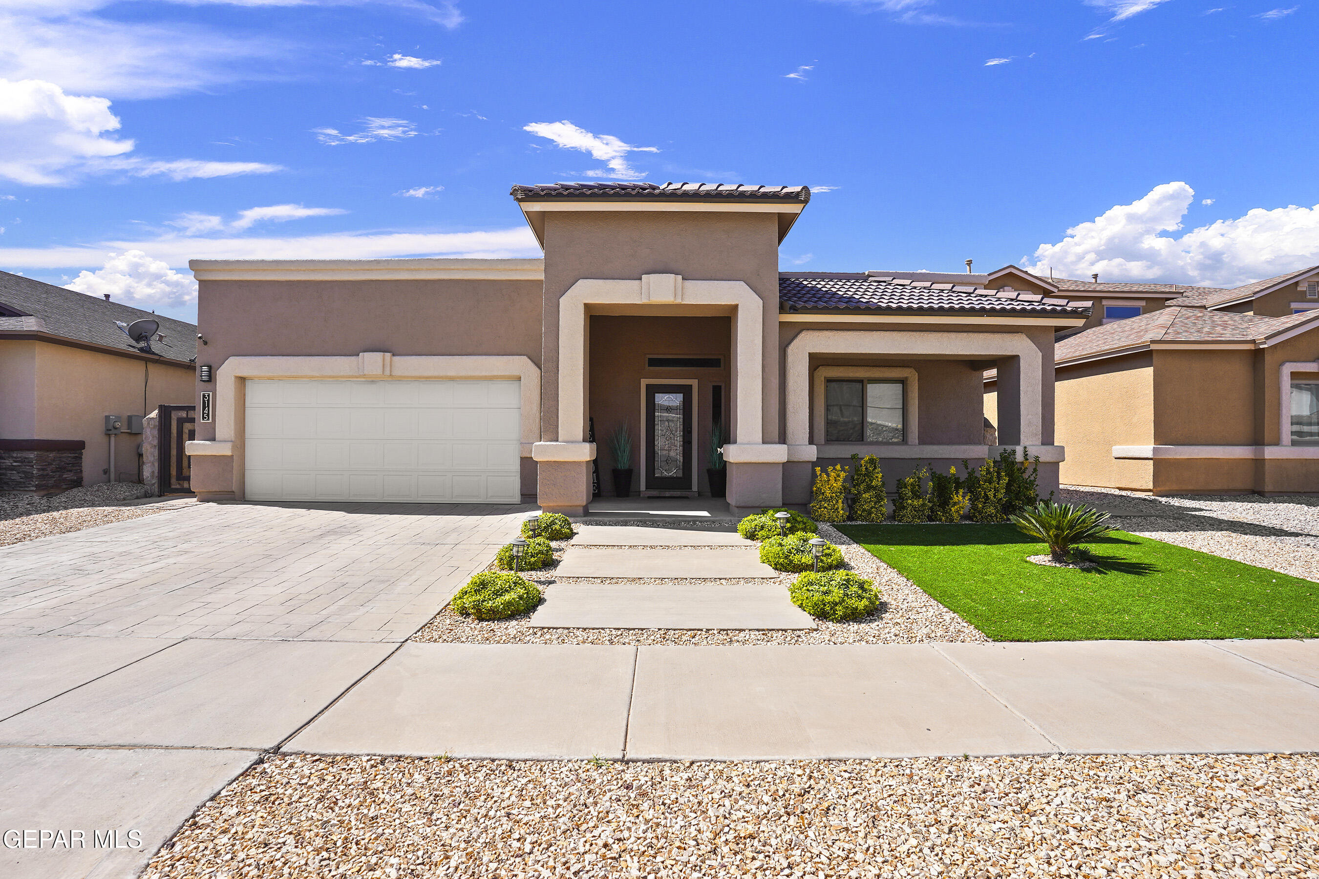 a front view of a house with garden