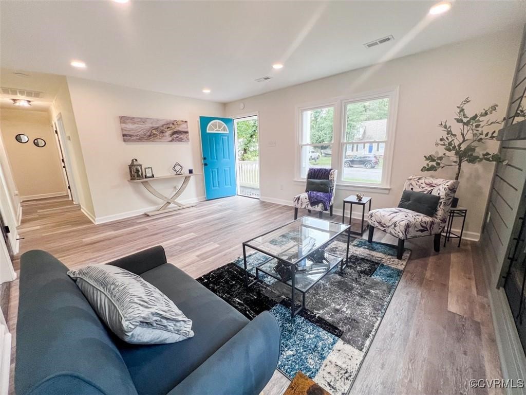 a living room with furniture and wooden floor