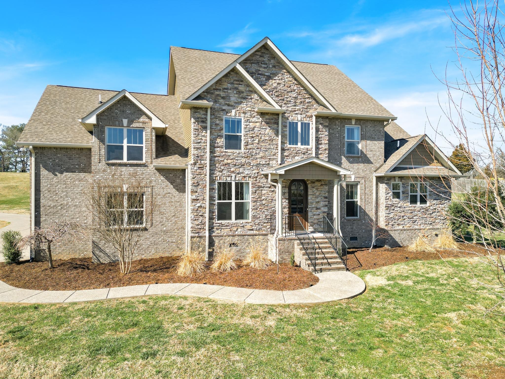 a front view of a house with a yard