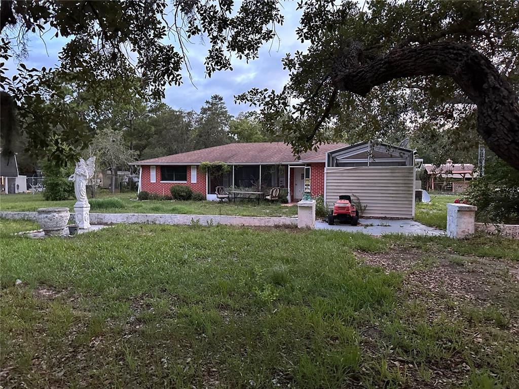 a front view of a house with a yard and green space