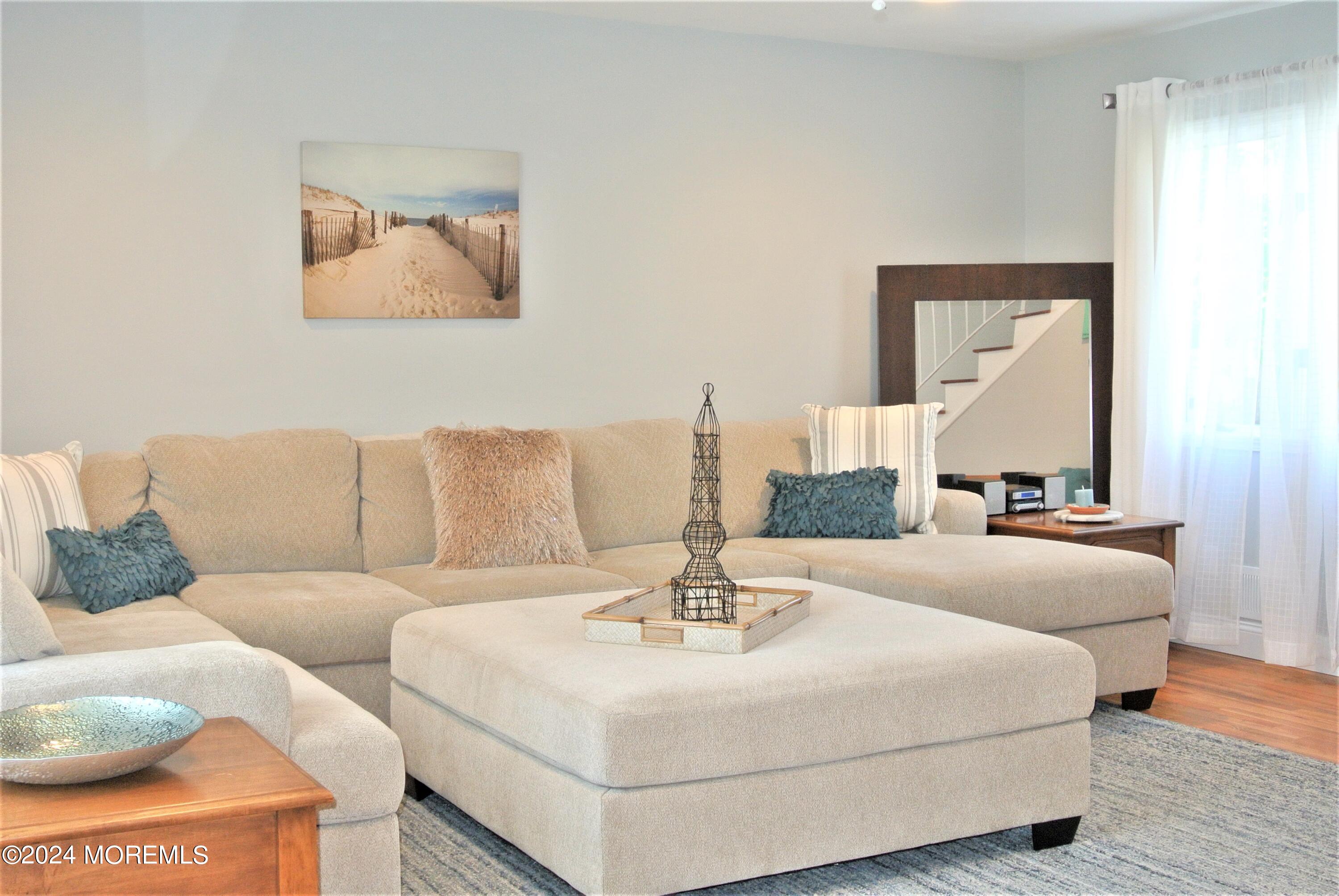 a living room with furniture and a mirror