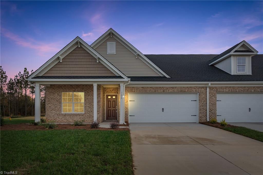 Front of Home w/ 2-Car Garage & Covered Porch