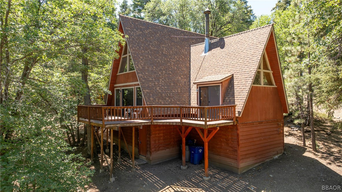 a view of a house with a balcony and furniture