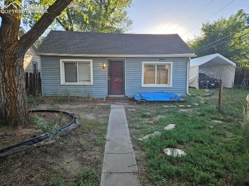 Bungalow-style house featuring a front lawn