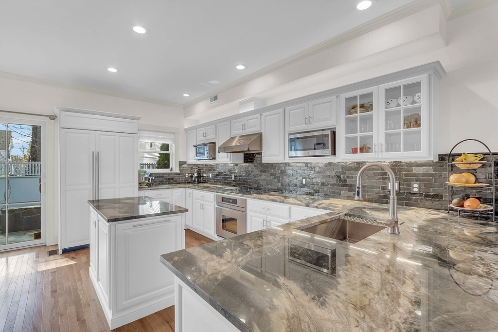 a kitchen with granite countertop a sink and cabinets