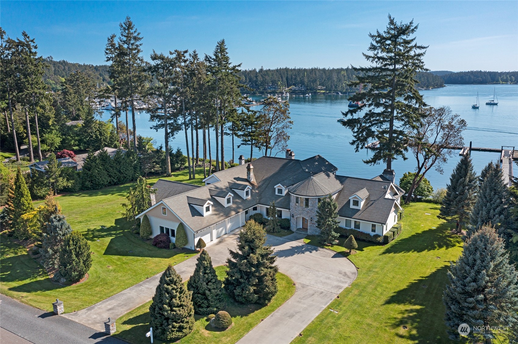 a view of a house with a yard and lake view