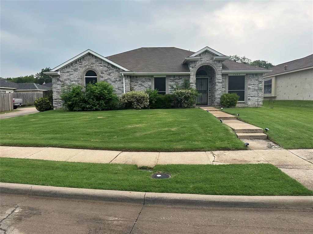 a front view of a house with a yard