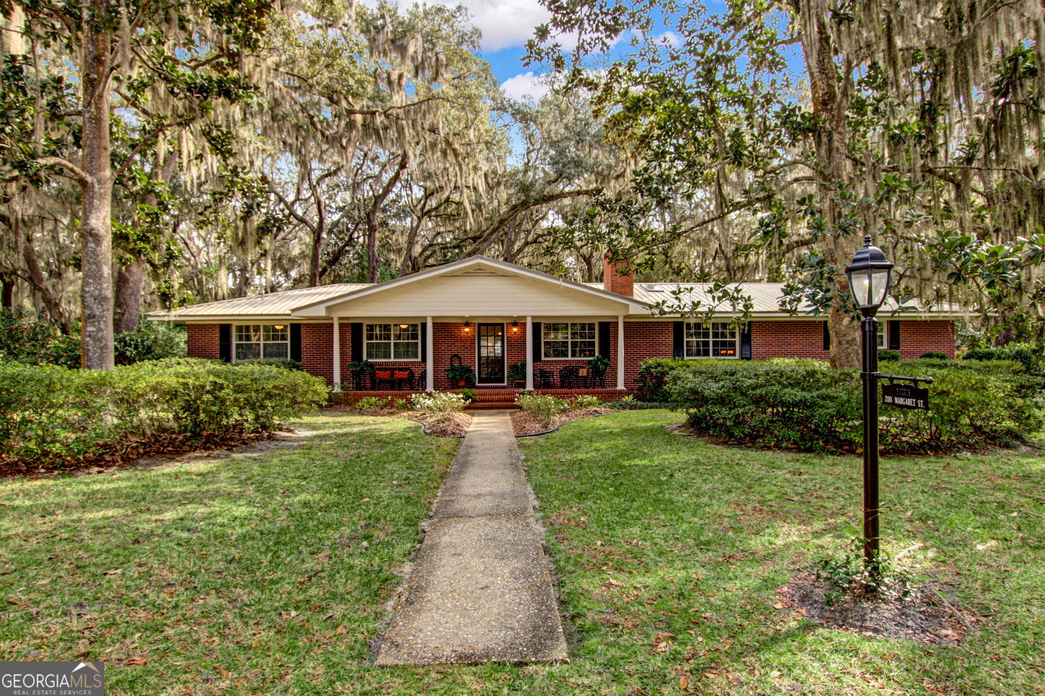 a front view of a house with yard porch and green space