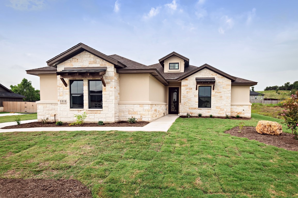 a view of a house with a yard and fence