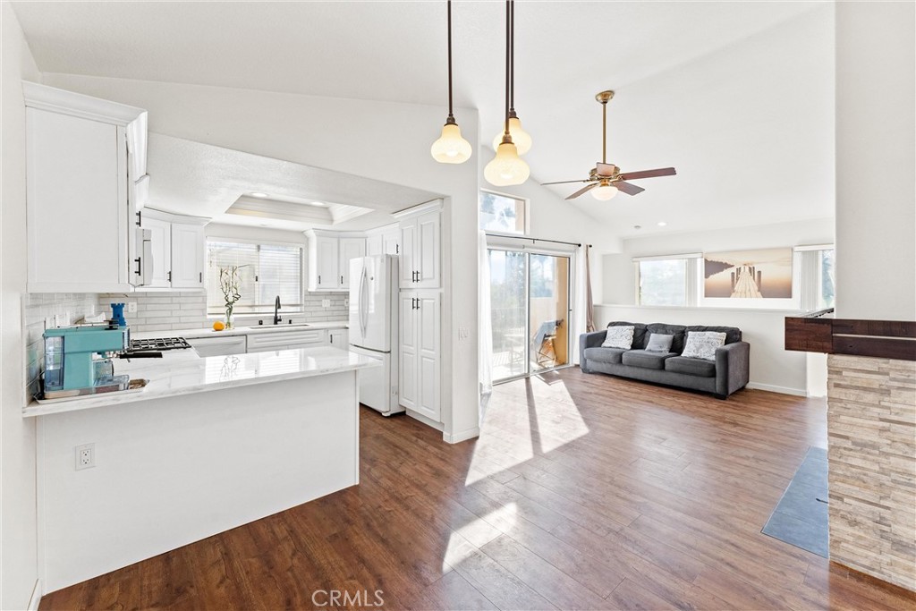 a view of a kitchen and dining room with wooden floor