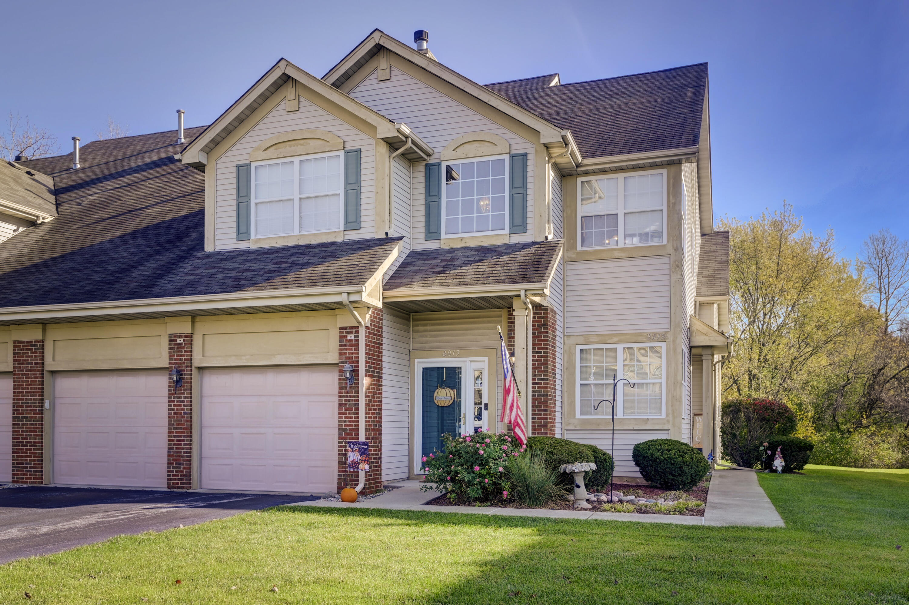 a front view of a house with garden