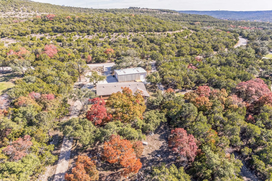 an aerial view of residential house with parking and yard