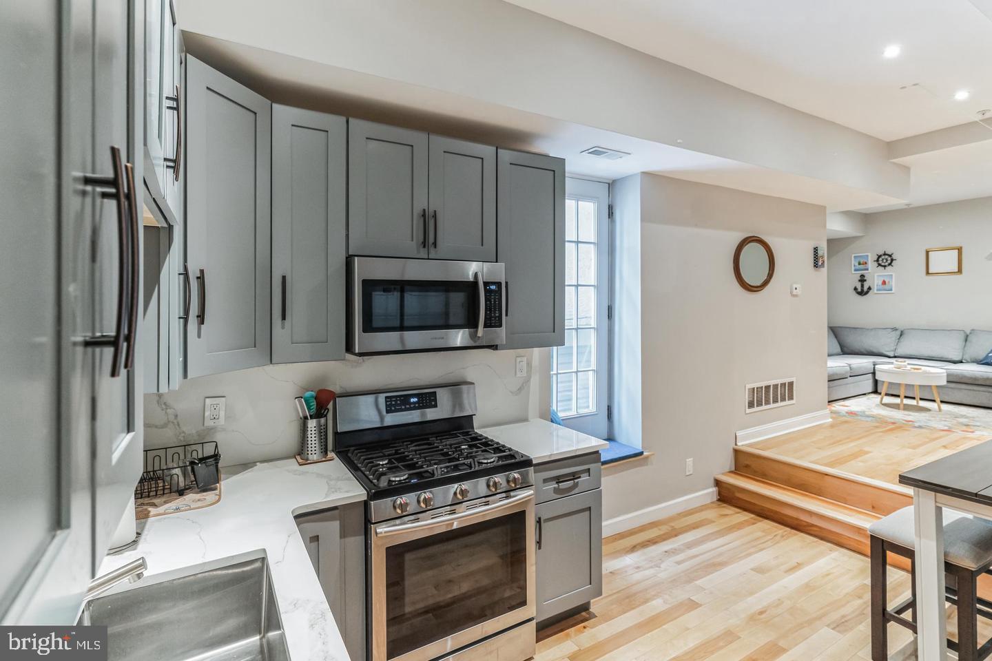 a kitchen with stainless steel appliances a stove a microwave and cabinets