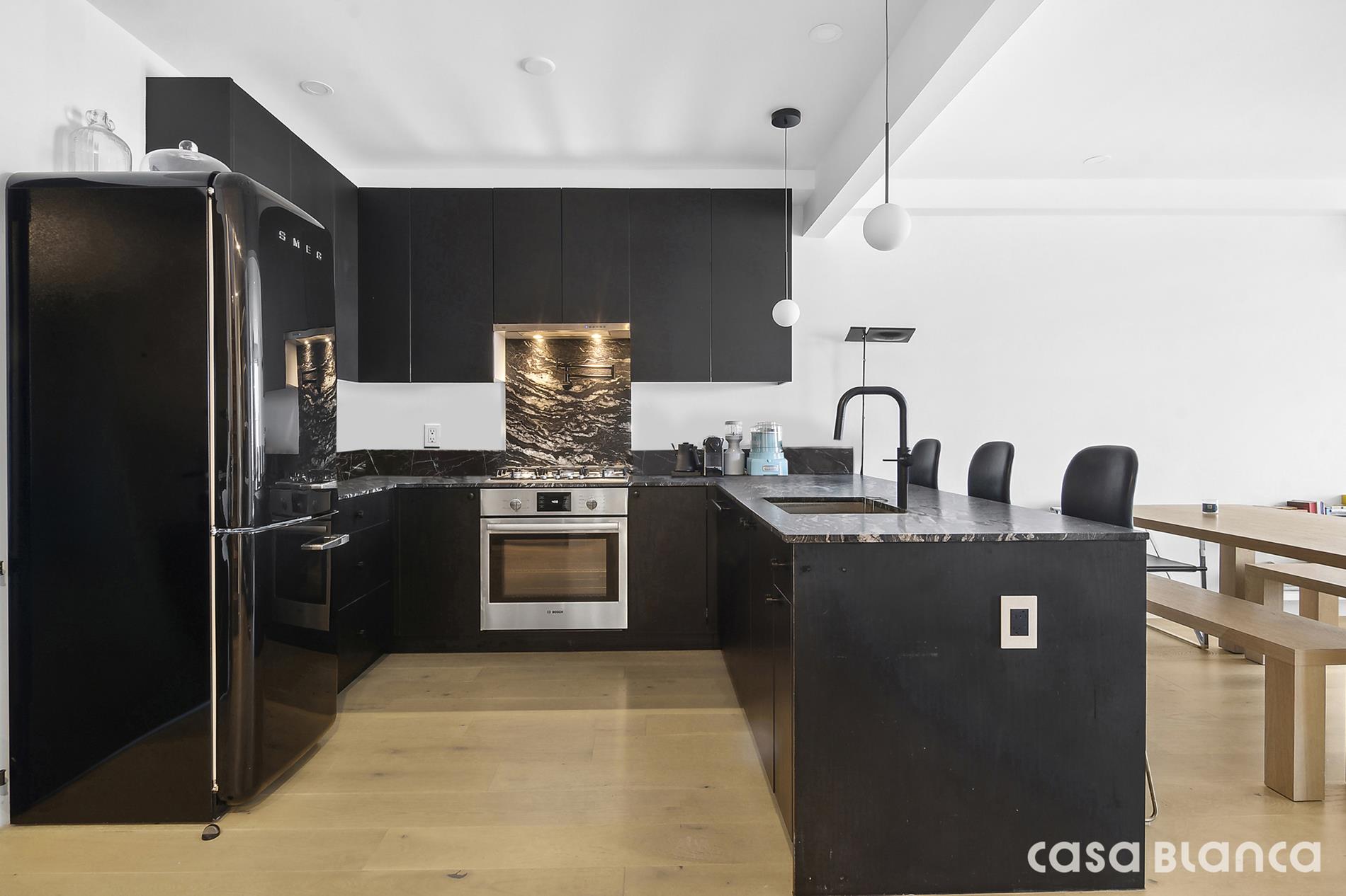 a kitchen with stainless steel appliances granite countertop a refrigerator and a stove