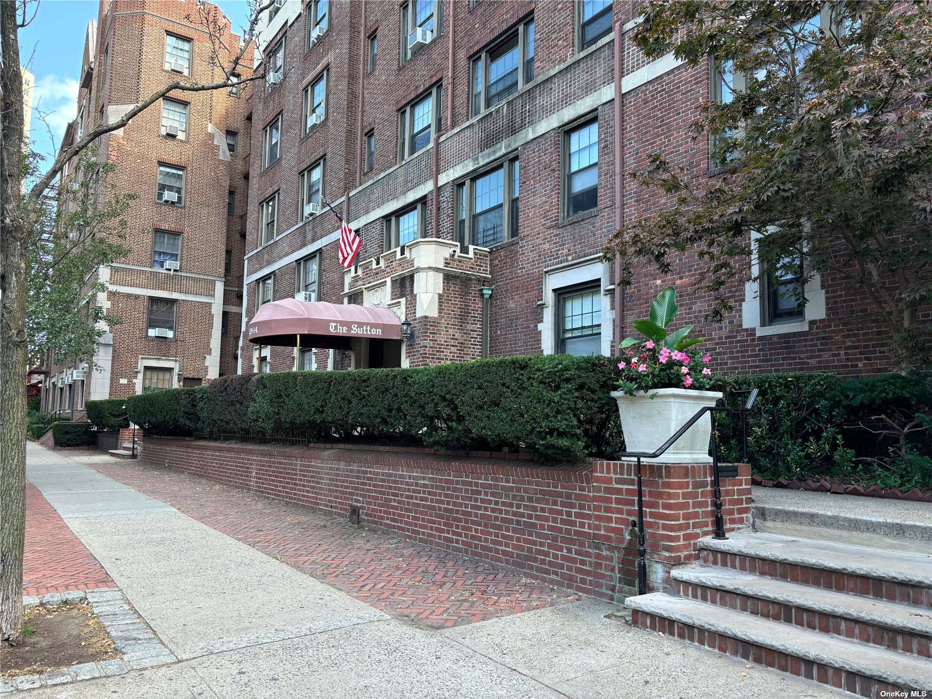 a front view of a building with garden