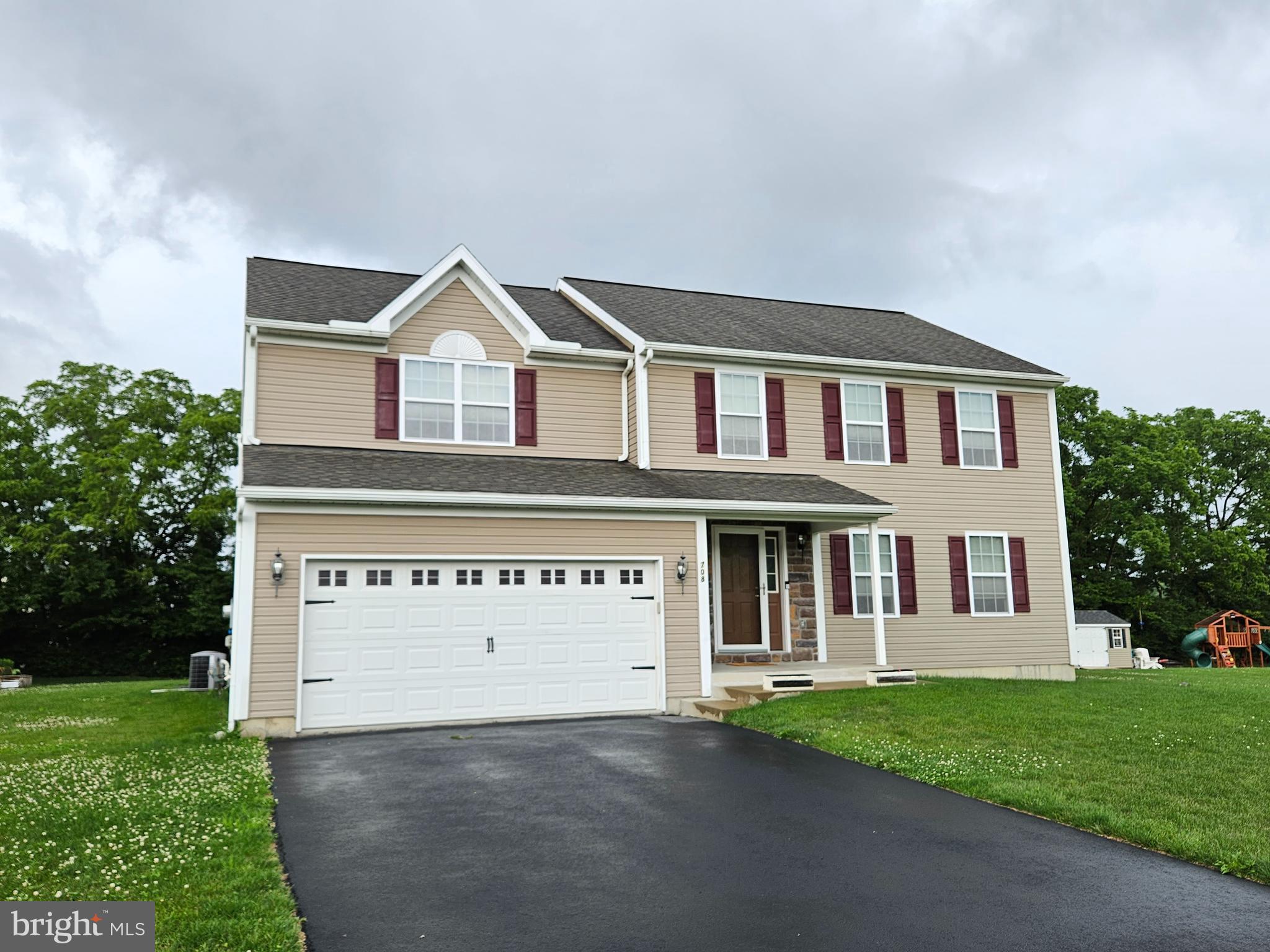 a view of house with yard and green space