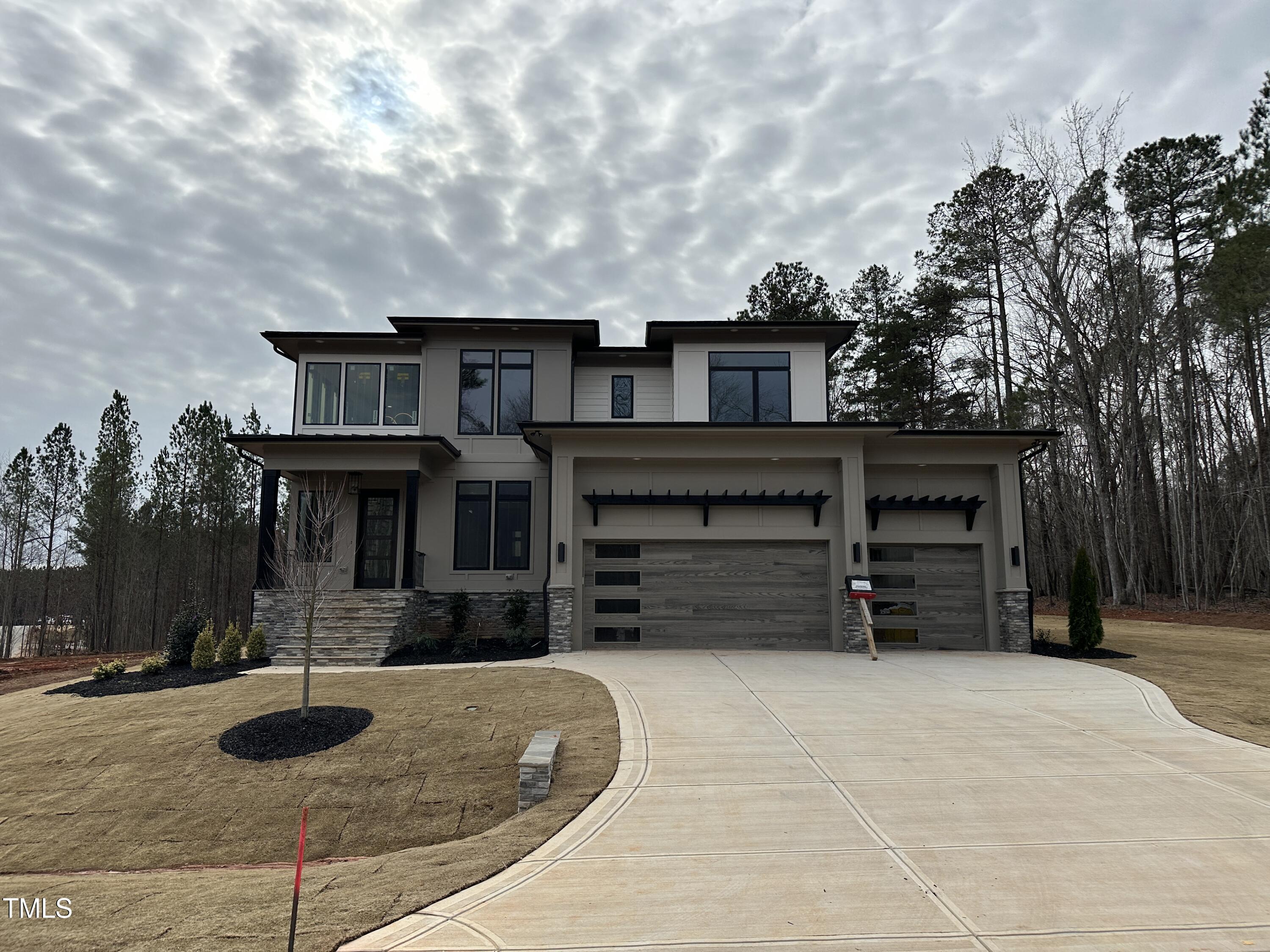 a view of a house with a yard and garage