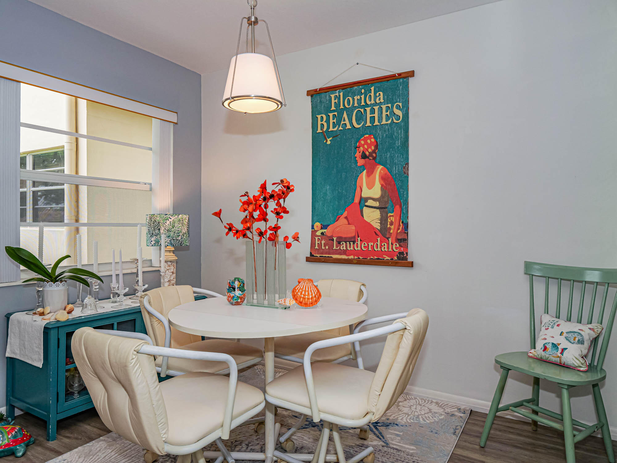 a dining room with furniture a kitchen view and a chandelier