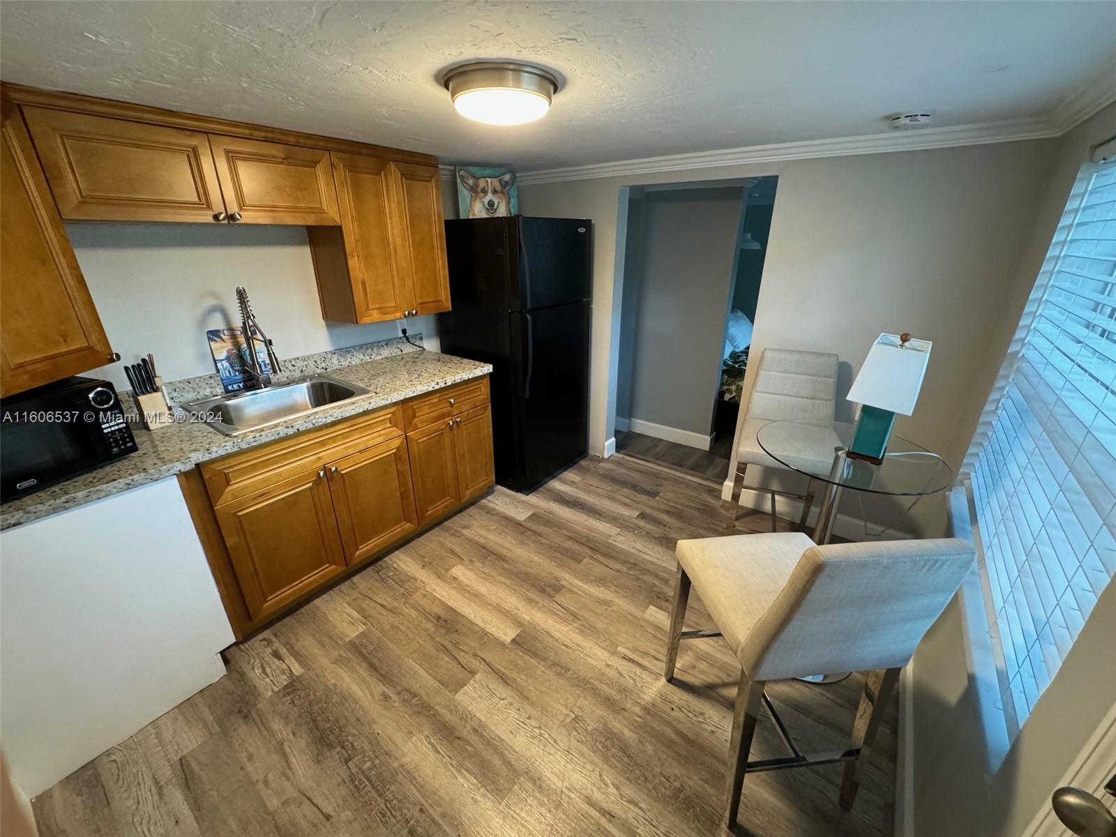 a kitchen with a sink appliances and cabinets