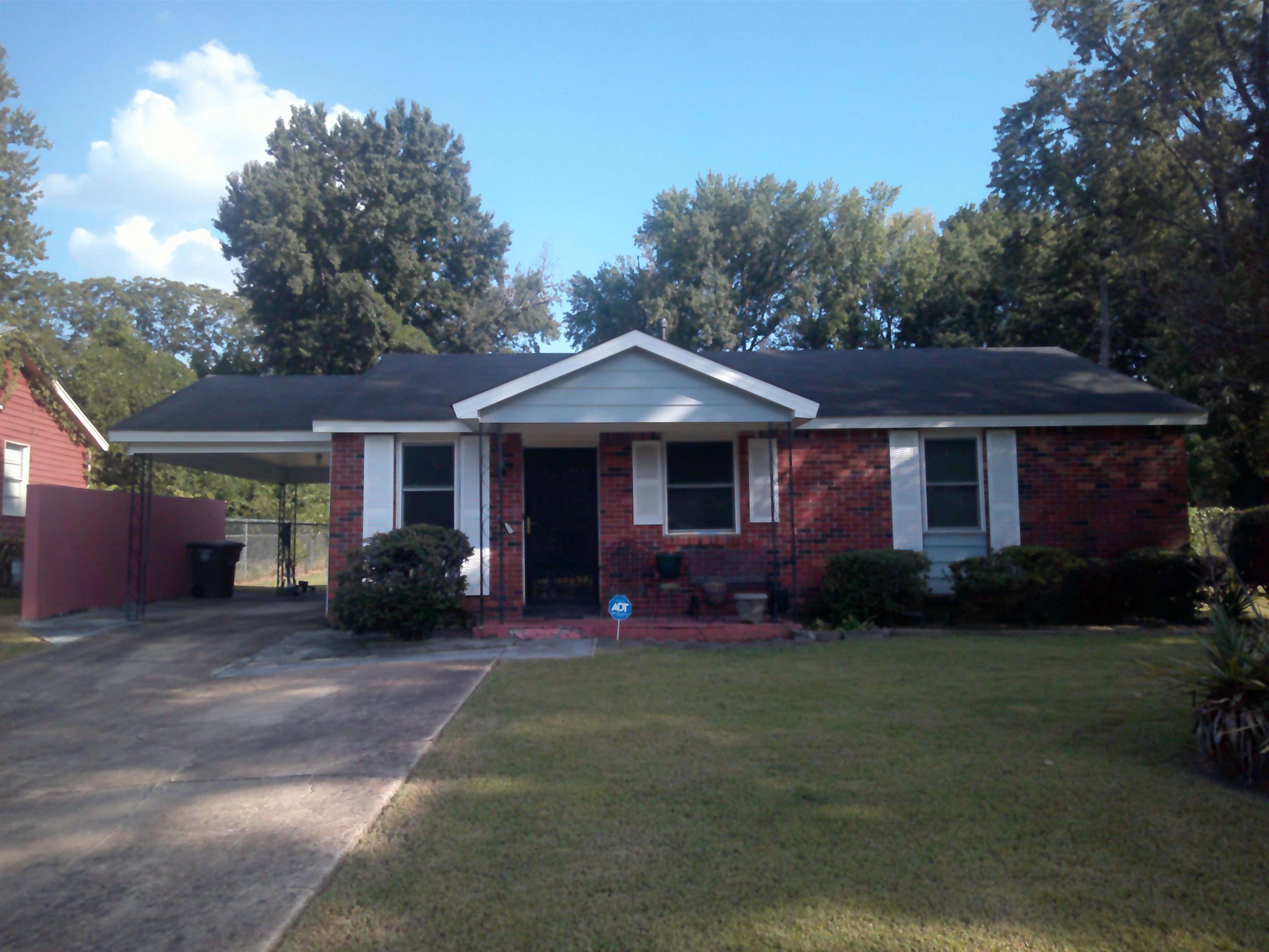 a front view of a house with a garden and porch