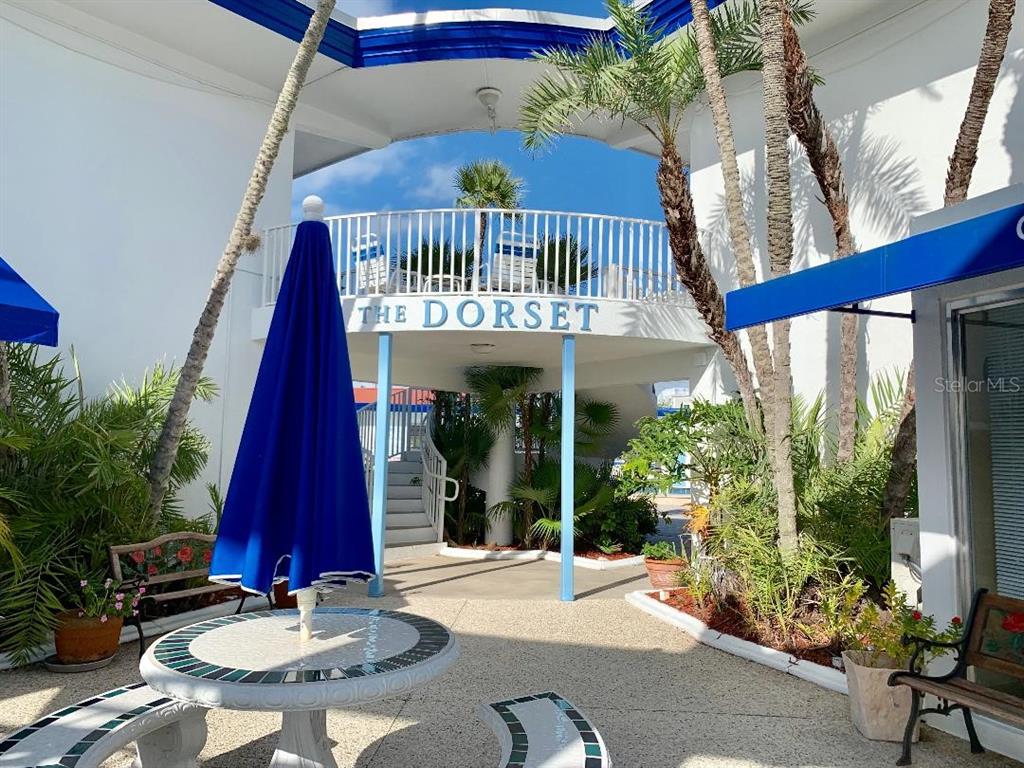 a view of a balcony with chairs and floor