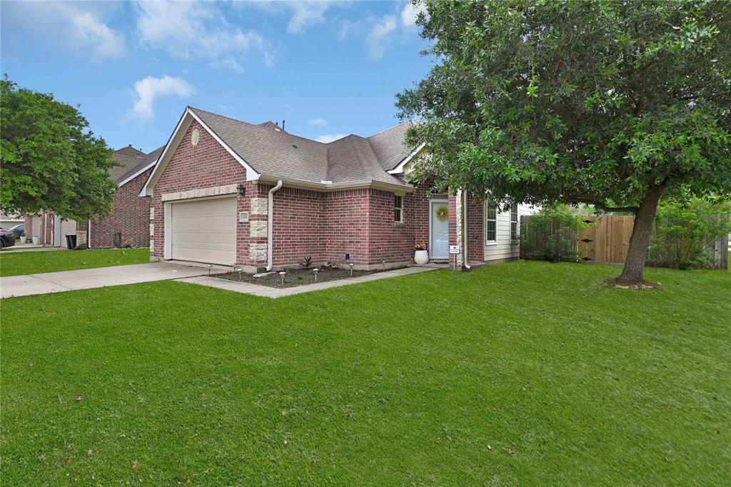 a front view of house with yard and green space