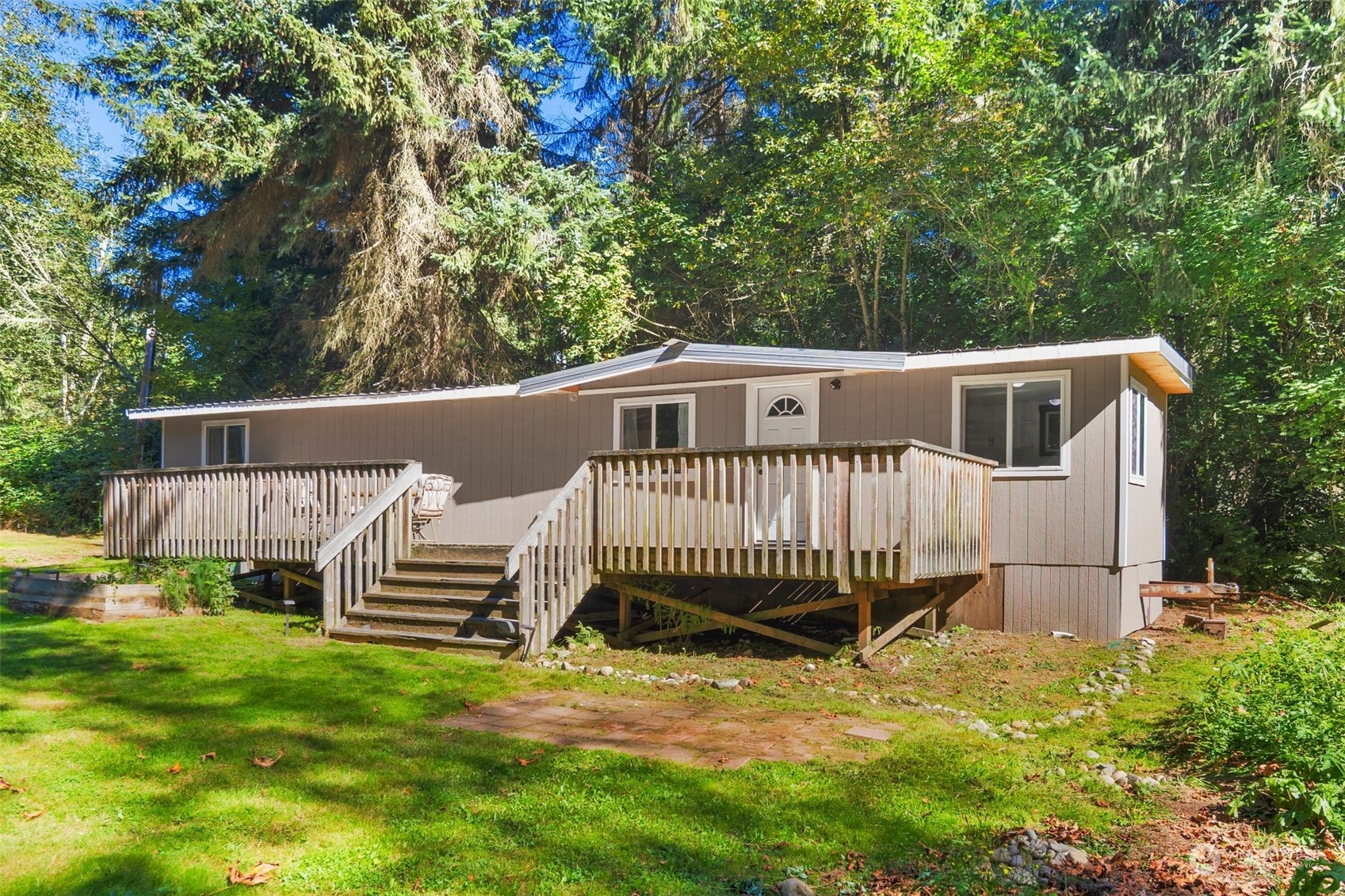 a view of a house with backyard and wooden fence