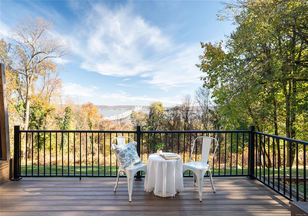 a view of a deck with two chair and wooden floor