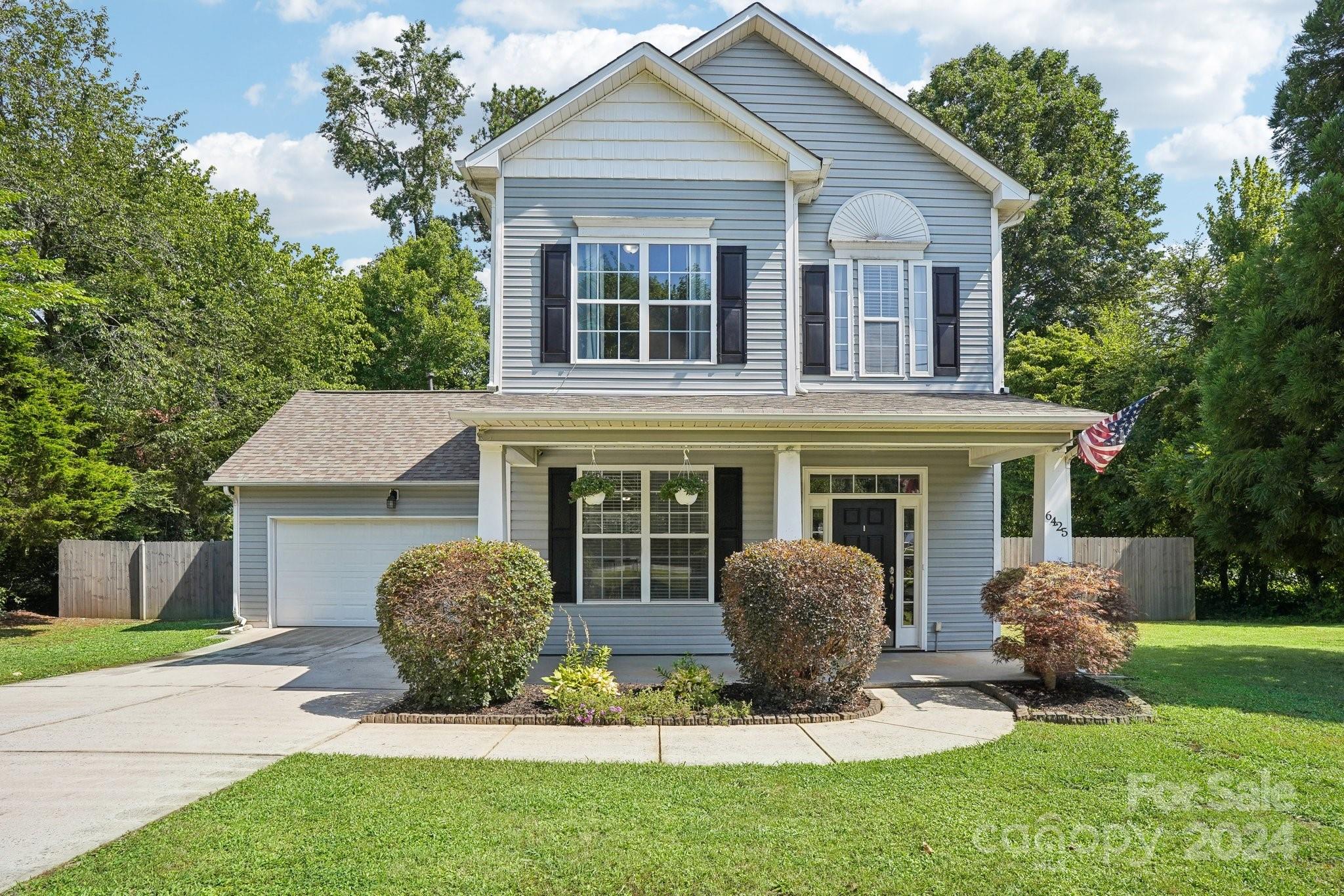 a view of a house with a yard and lawn chairs with a yard