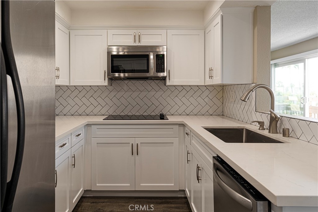 a kitchen with sink cabinets and fireplace