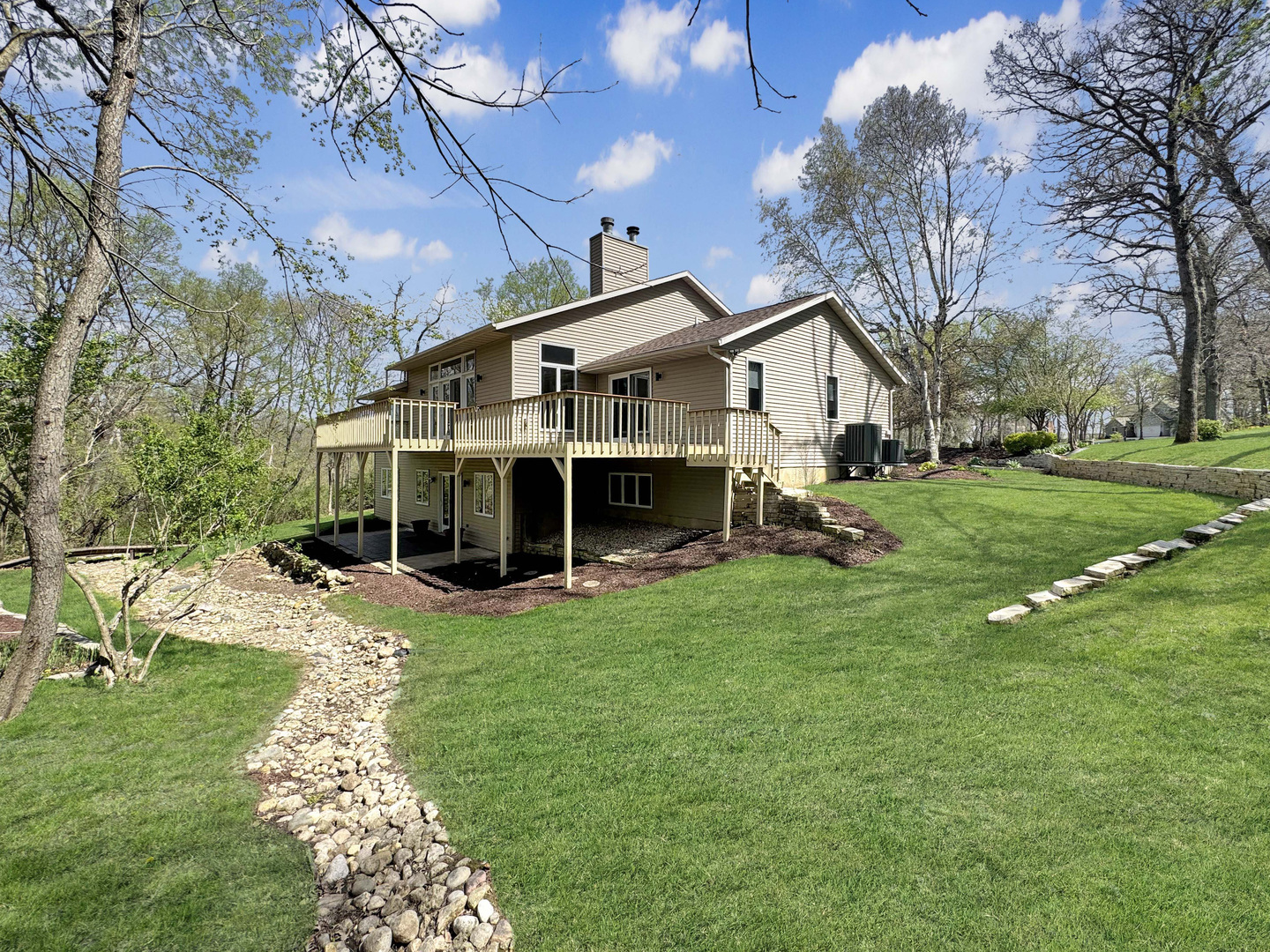 a view of a house with a yard patio and fire pit