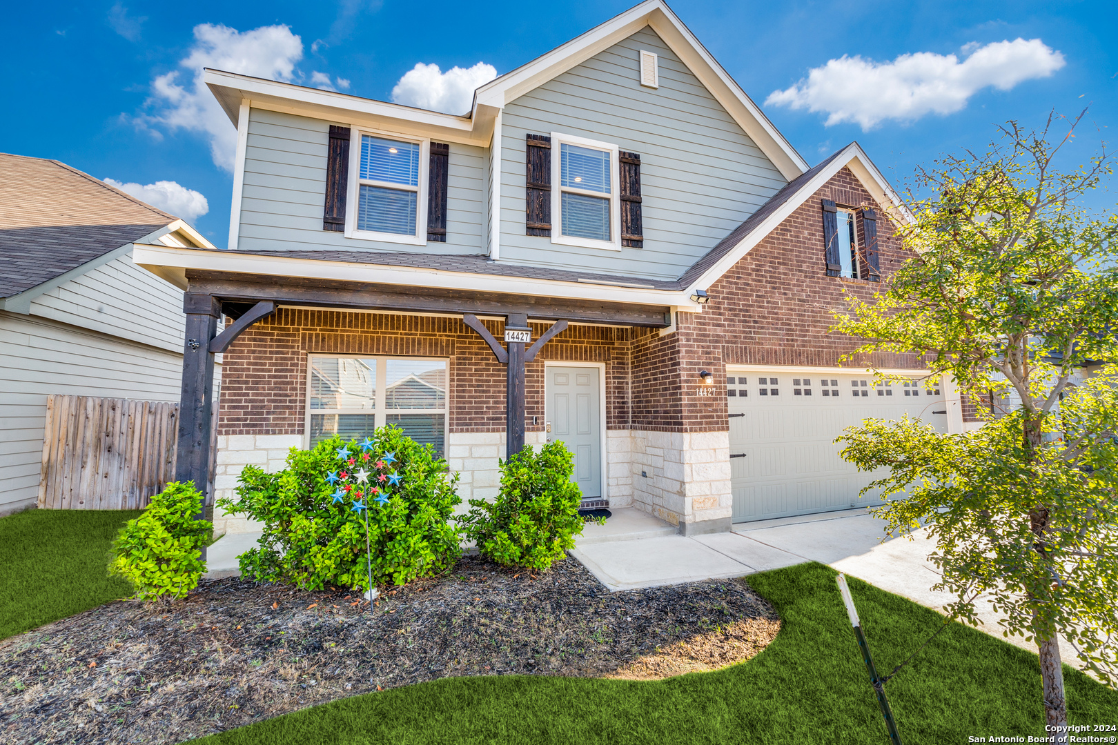 a front view of a house with garden