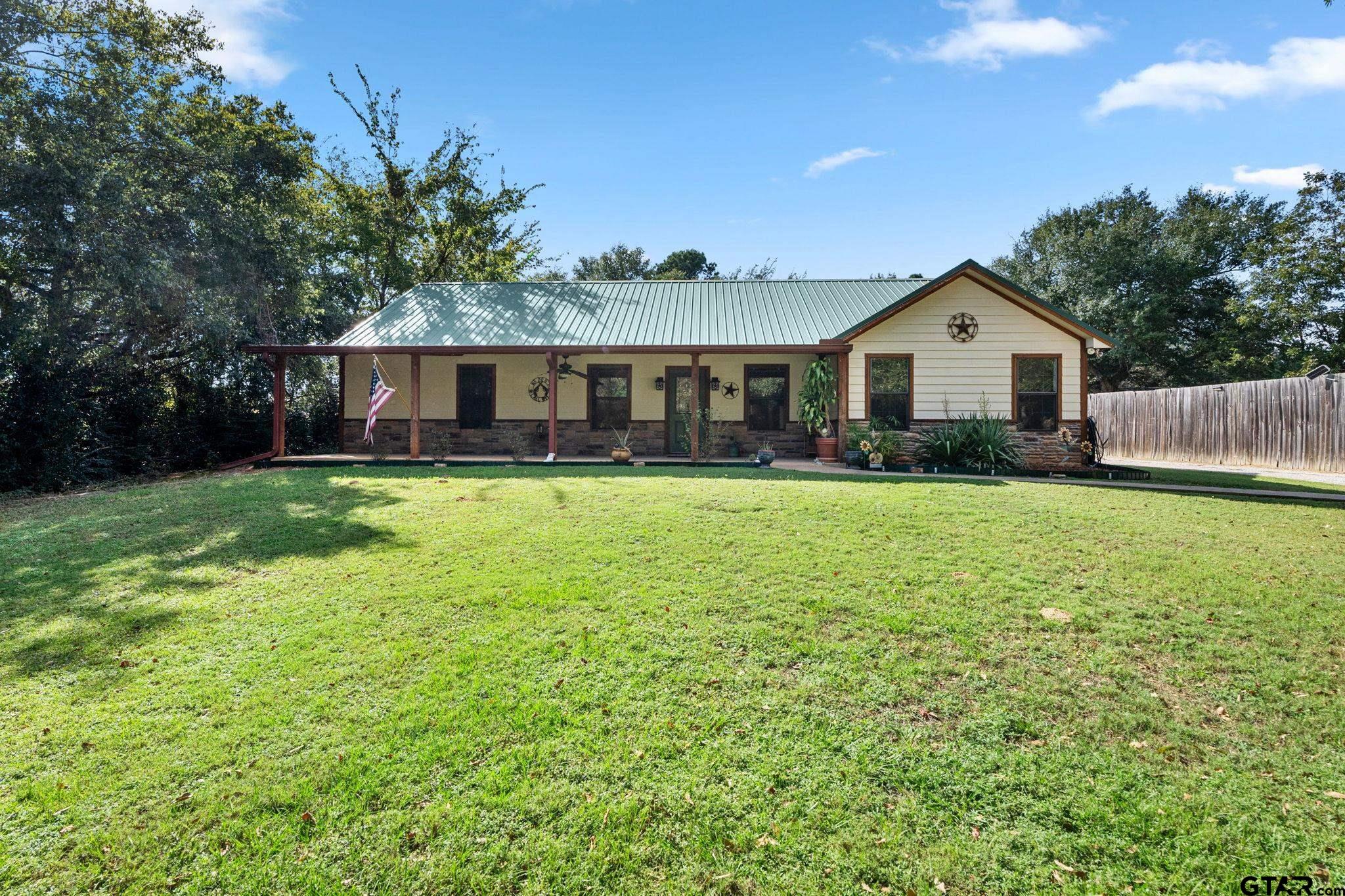 a front view of house with yard and green space