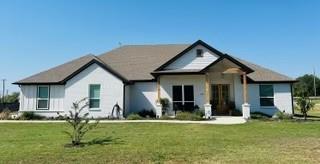 a front view of house with yard and green space