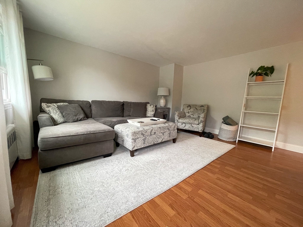 a bedroom with furniture and a wooden floor