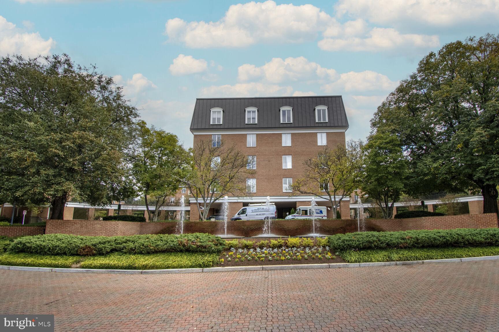 a view of a brick building next to a yard