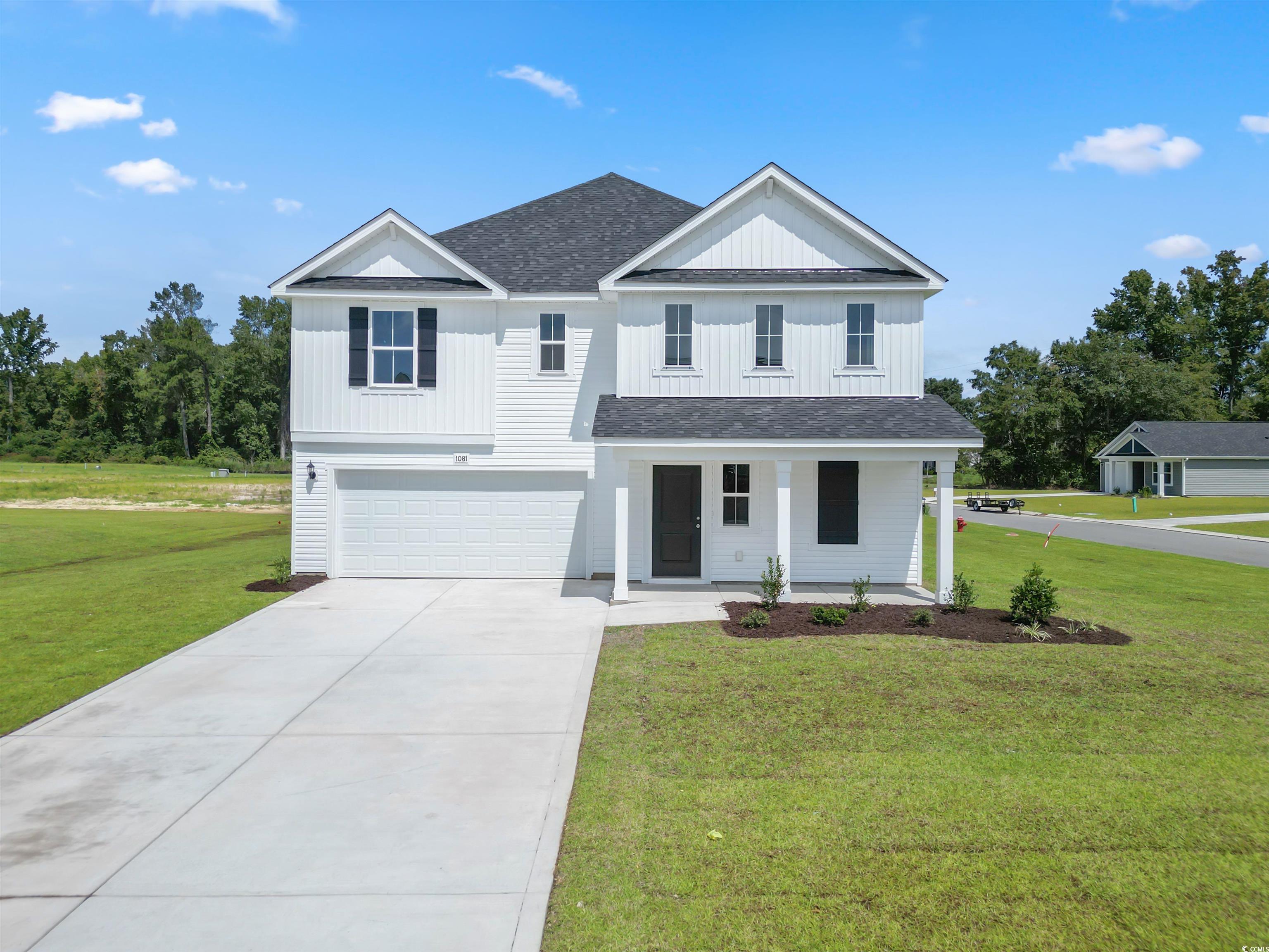 View of front of property with a garage, a porch,