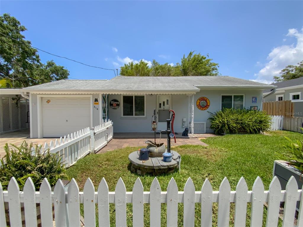 a front view of house with a garden