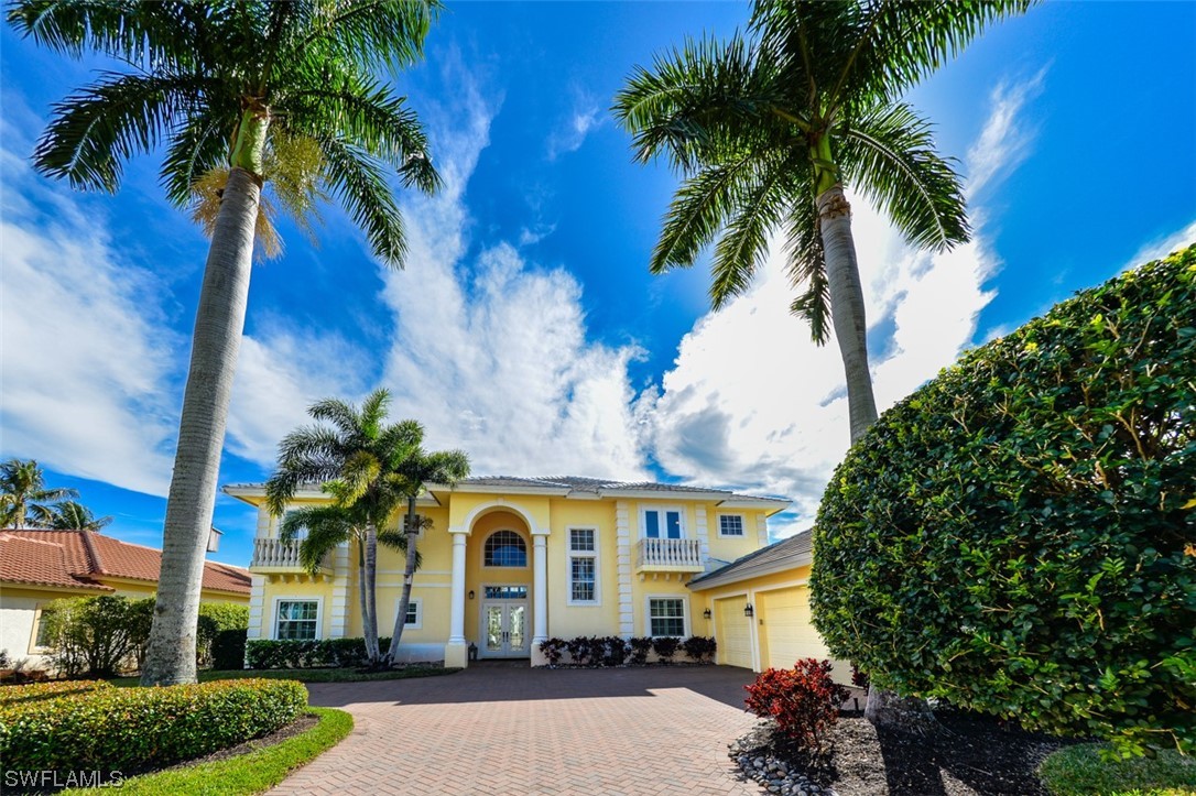 a front view of a house with a palm tree