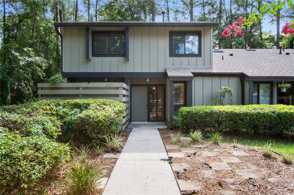 a front view of a house with lots of green space