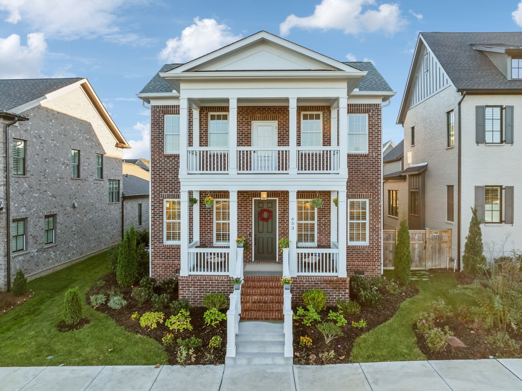 front view of a brick house with a small yard