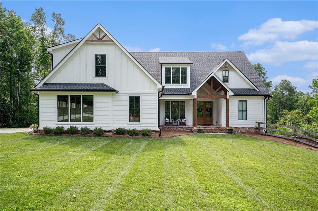 a front view of a house with a garden