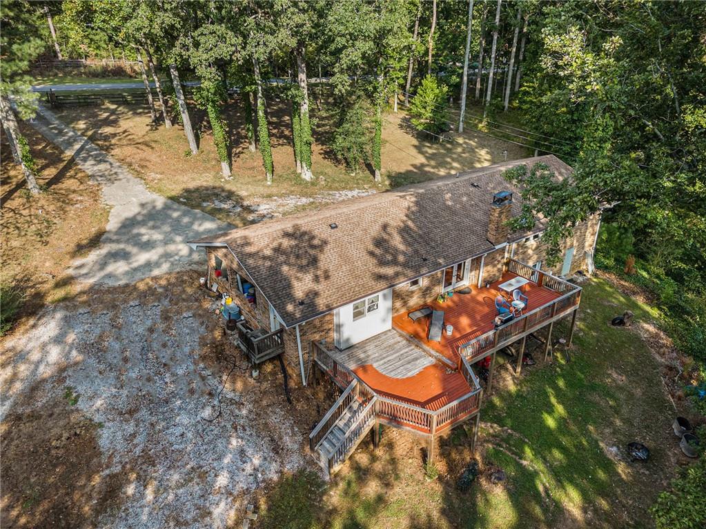 an aerial view of a house with a yard and lake view