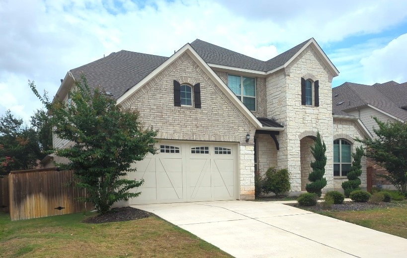 a front view of a house with a yard and garage