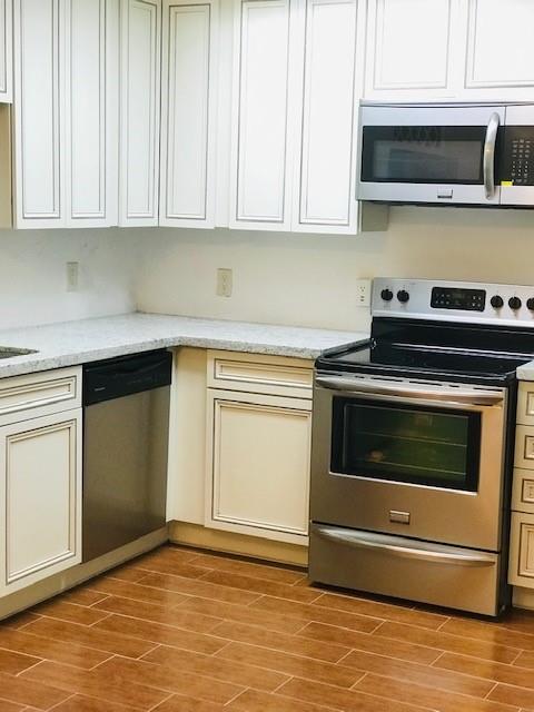 a kitchen with granite countertop a stove and a sink