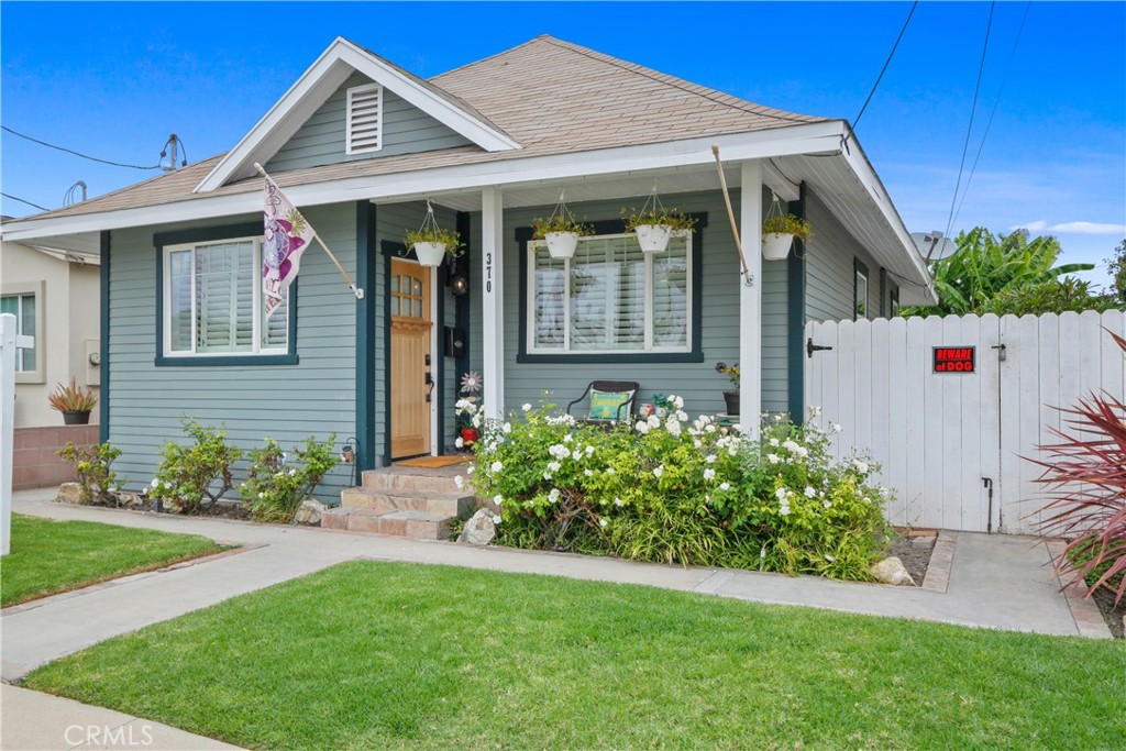 a front view of a house with garden