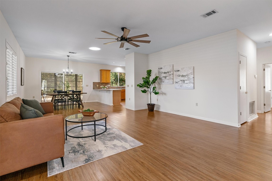 a living room with furniture and a wooden floor